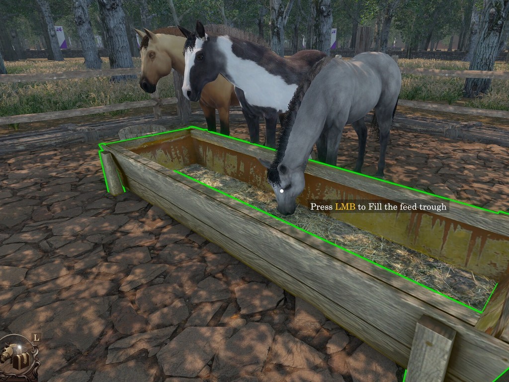 Real gameplay screenshot: horses gathered at a feed trough inside a fenced paddock